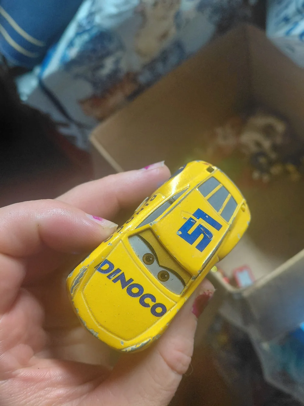 Disney Pixar Cars Cruz Ramirez die-cast toy car in her yellow Dinoco racing live
